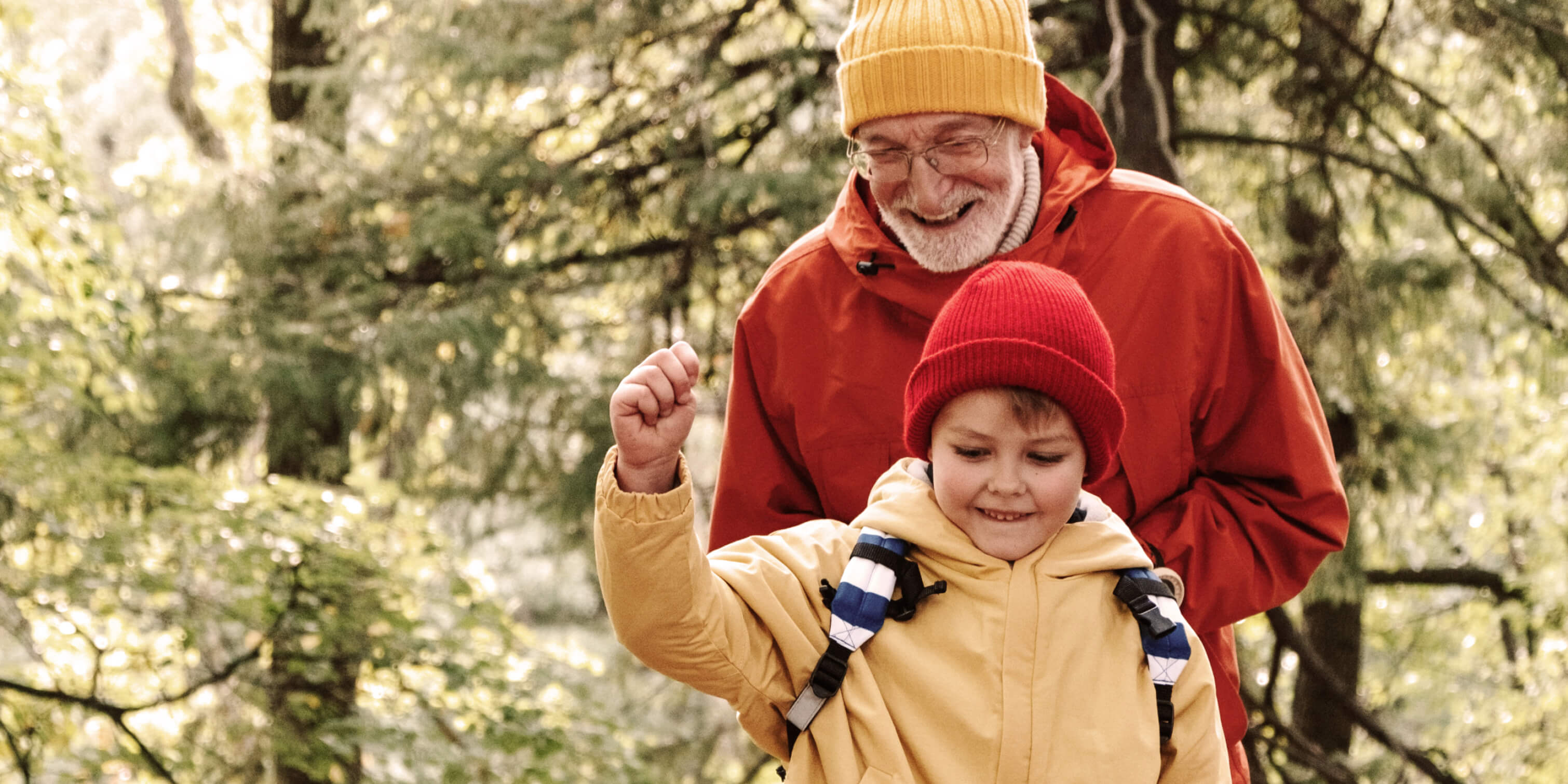 A senior man and a child in nature.