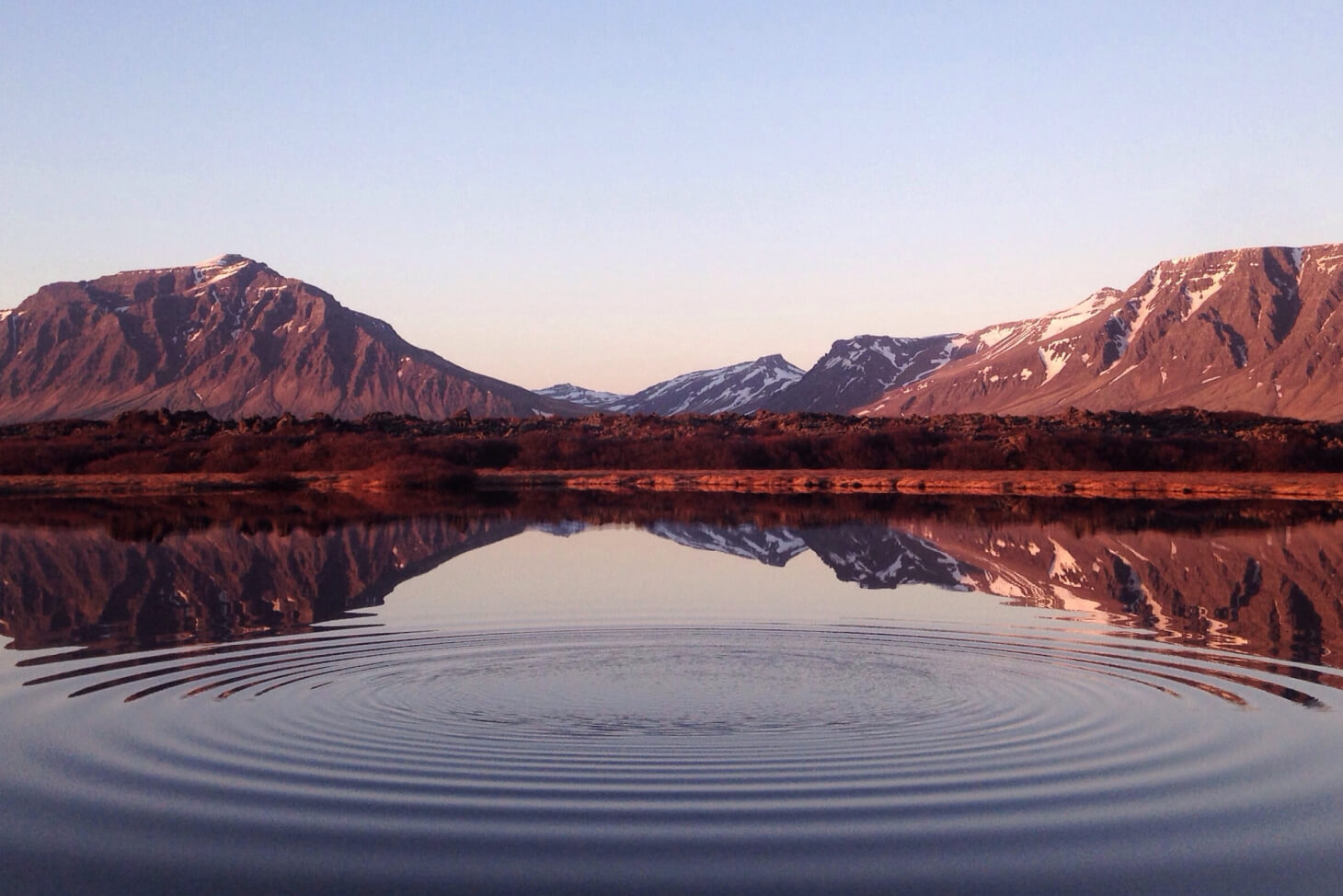 A big lake surrounded by tall mountains.