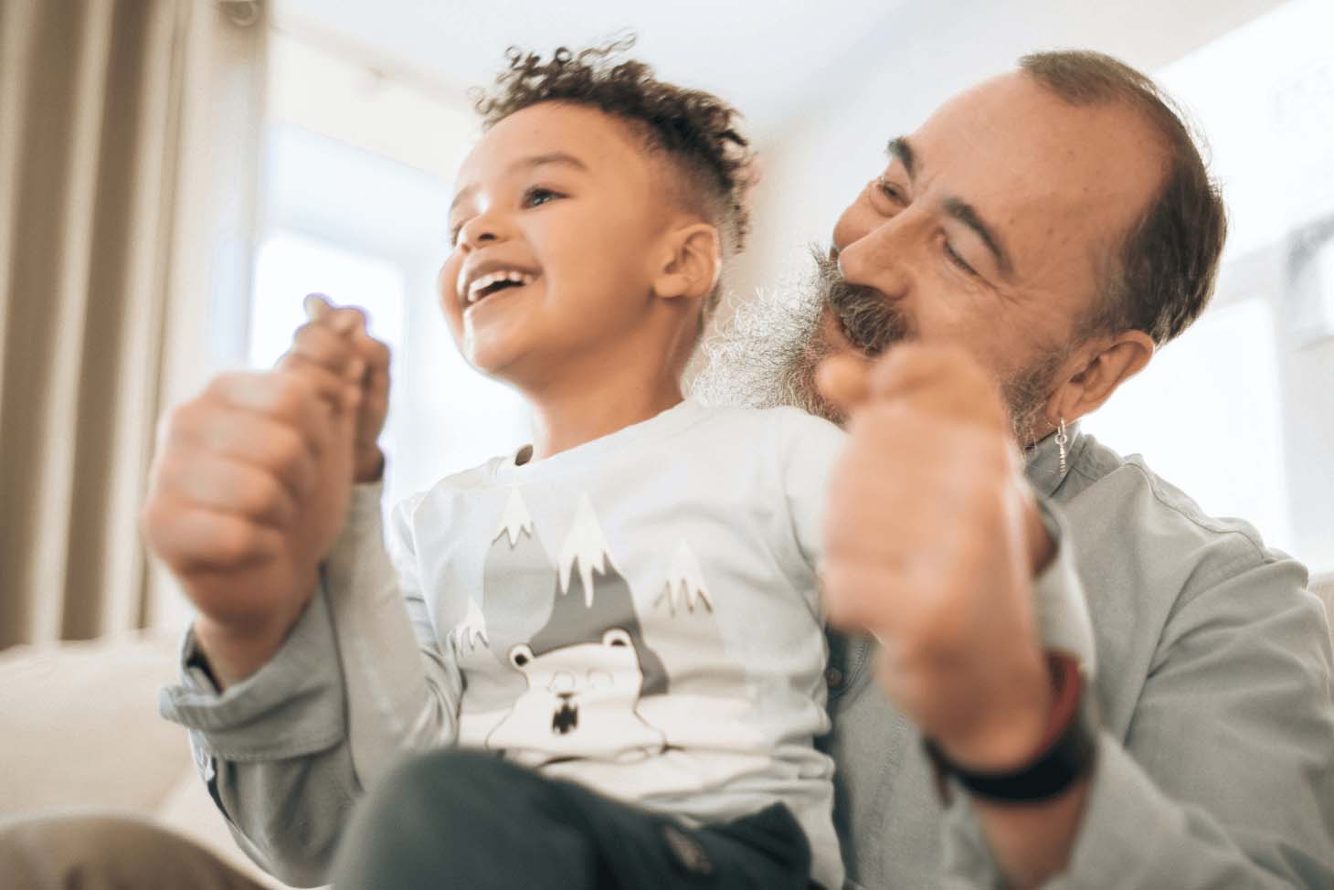 A man playing with a child in an indoor environment.